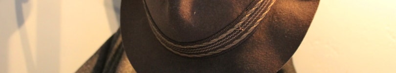 Close up shot of a trilby hanging up on a coat and hat stand